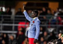Lumumba Vea”: The Living Statue Who Carried Congo’s Spirit at AFCON 2025 Michel Nkuka Mboladinga, also known as “Lumumba Vea,” standing motionless on a pedestal with his right arm raised, mimicking Patrice Lumumba’s statue during a DR Congo match at AFCON 2025